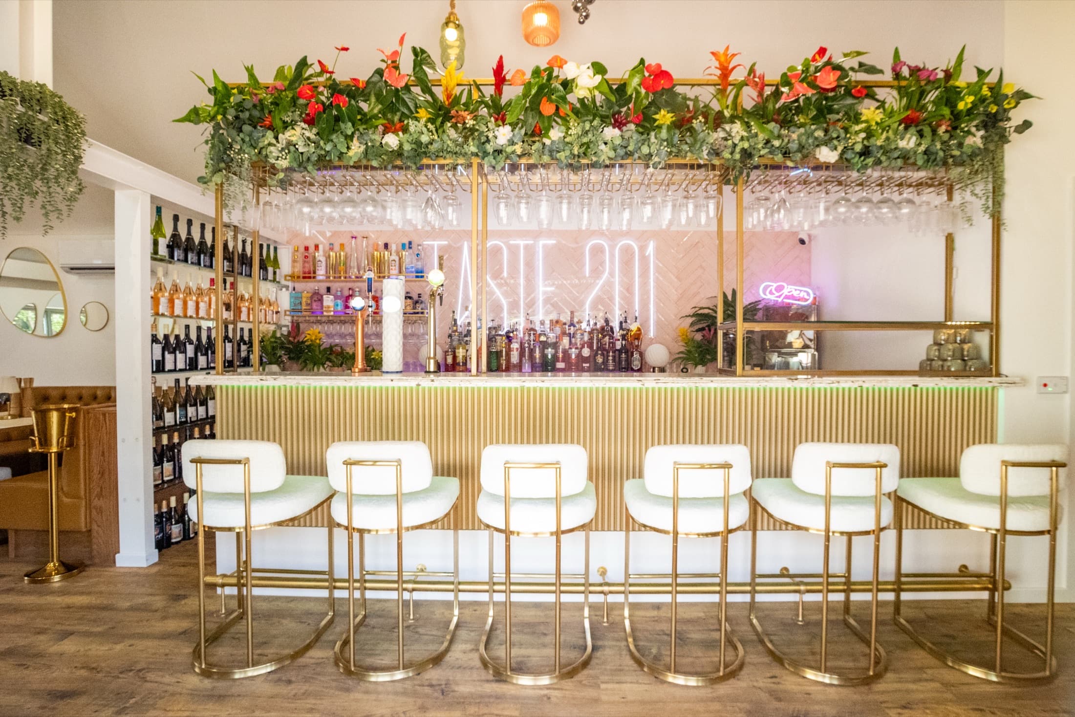 Taste Smokehouse bar with neon sign and gold stools